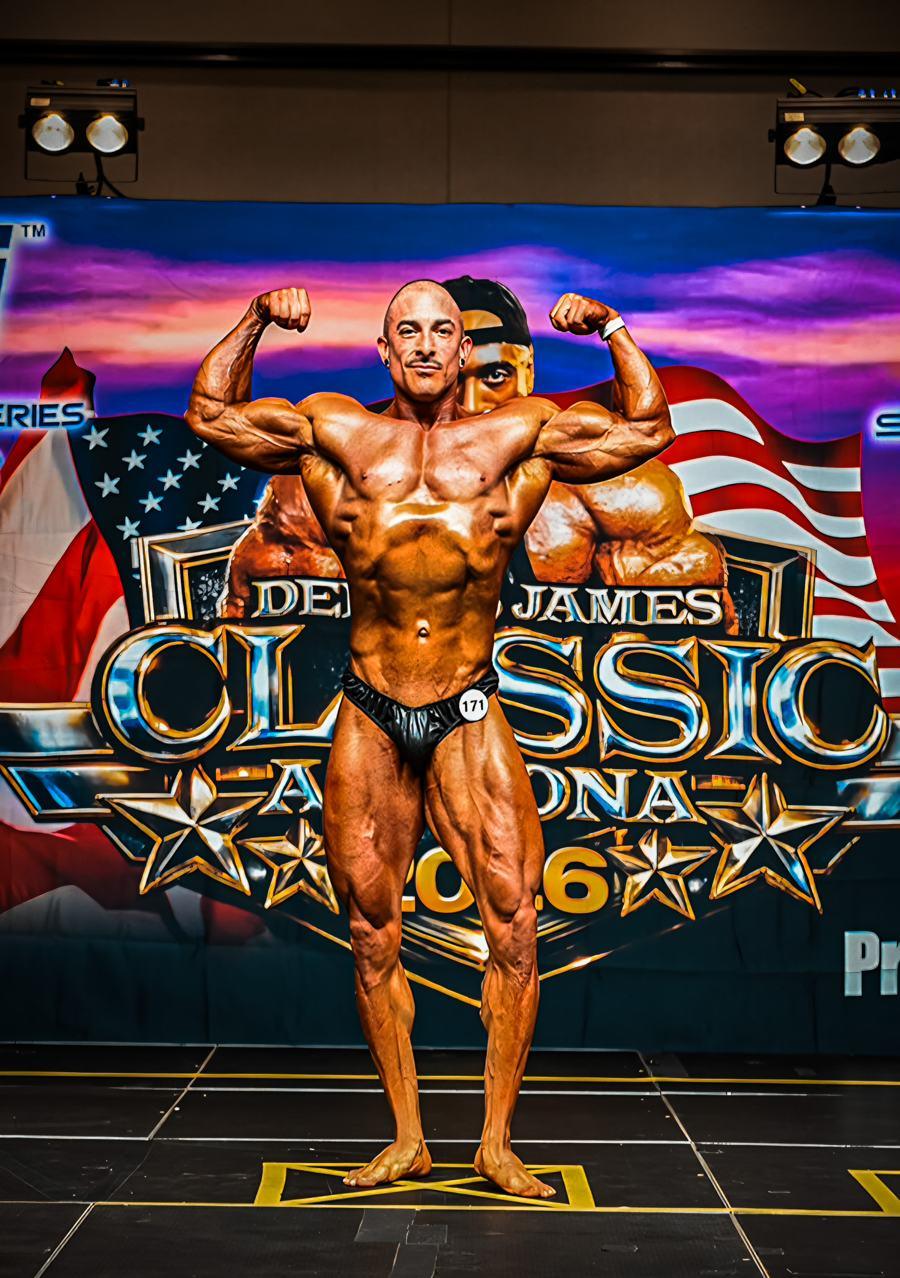 Adam Solis hitting a front double biceps on stage