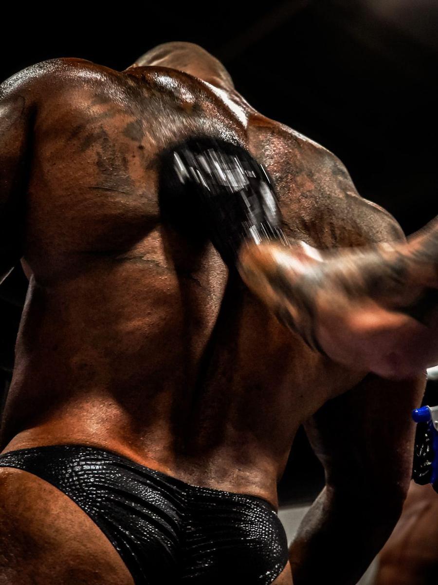 Competitor getting oiled up backstage before walking on stage