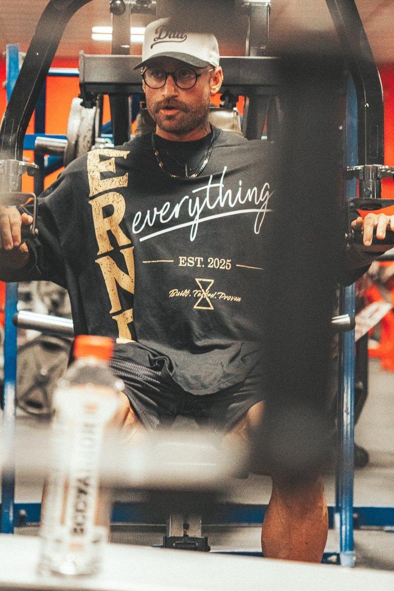 Athlete on a chest press machine in an ERND Everything tee
