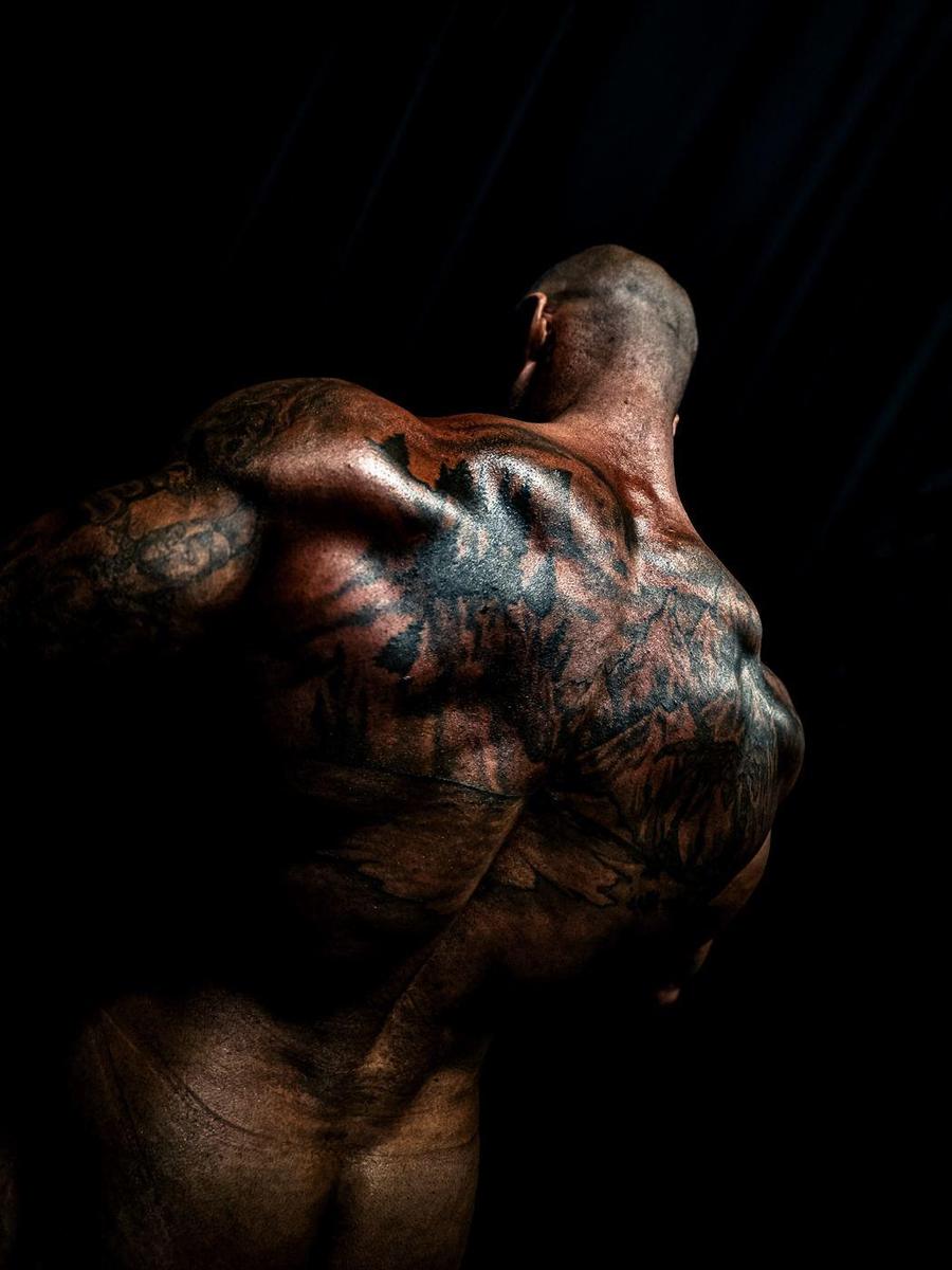 Low-key shot of a heavily tattooed back and shoulders